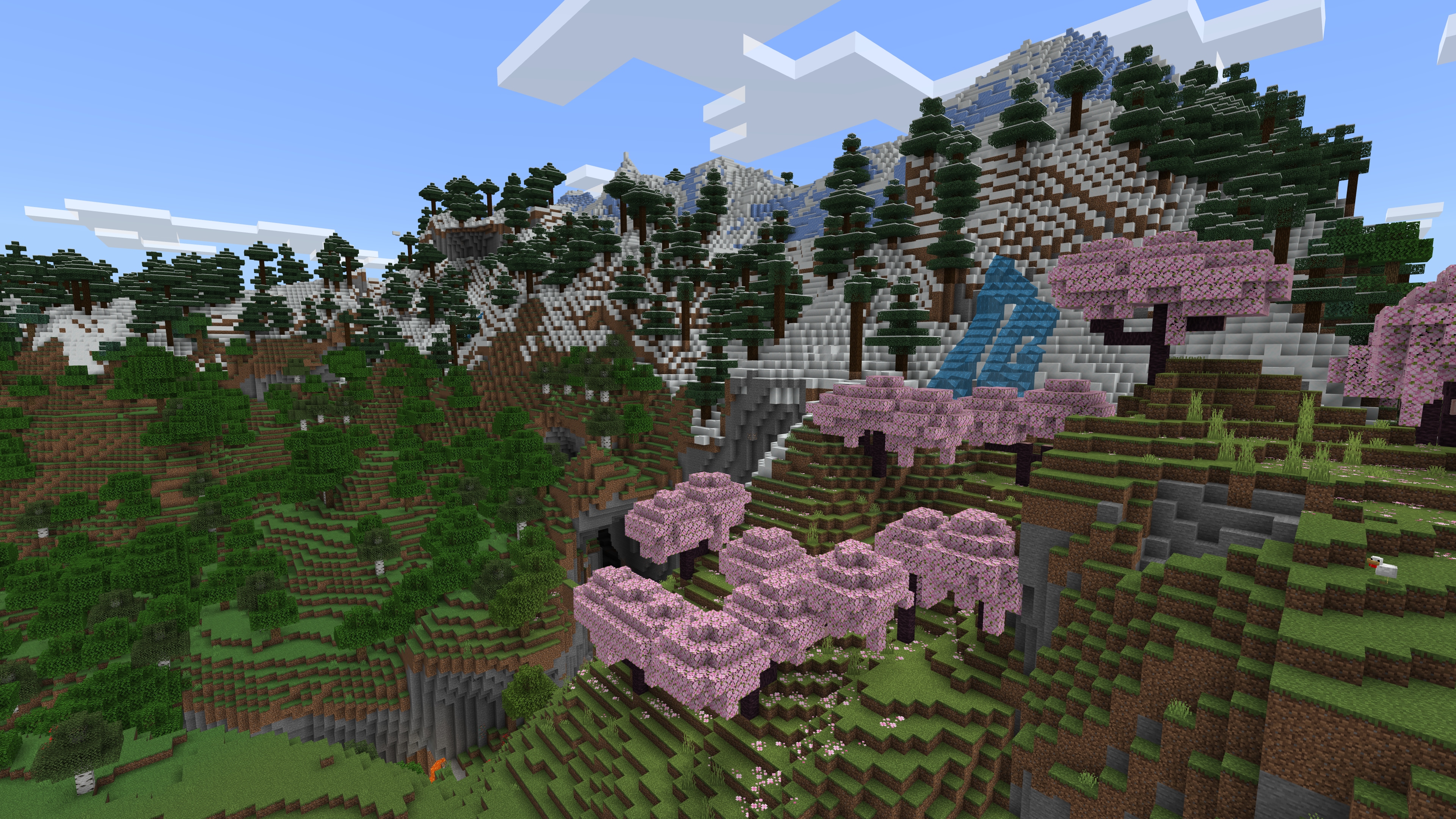 A snow-topped mountainside in Minecraft is covered in oak, pine, and cherry trees.