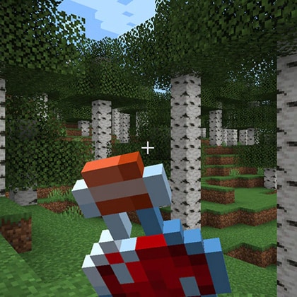 A healing potion is being held by a player in the middle of a birch tree forest